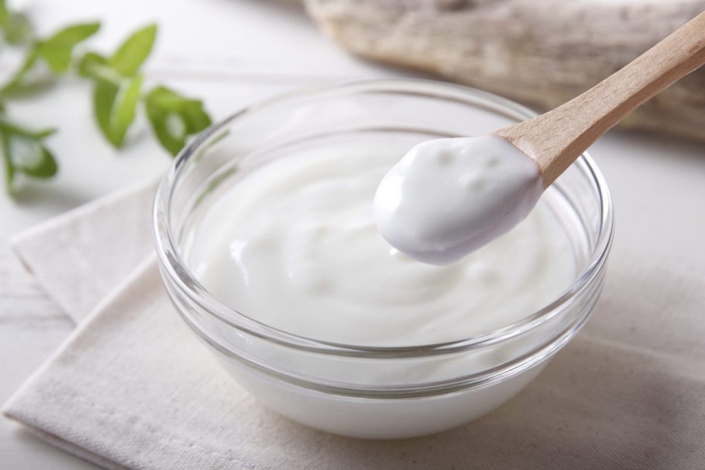 While yogurt is fine for adults, the cold temperature harms an infant's weak digestive system.