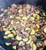 Mushrooms and zucchini simmering in the pan